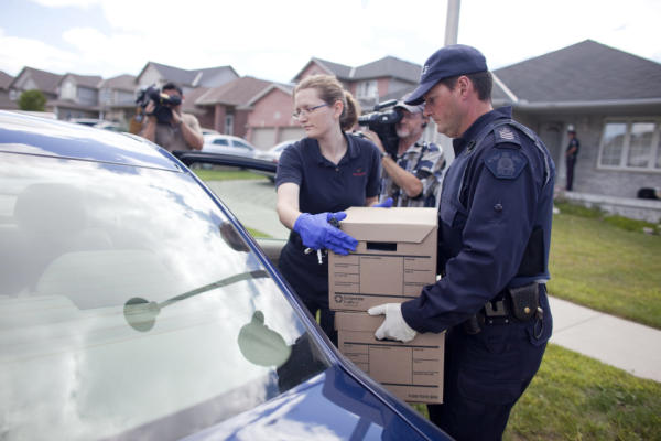 RCMP investigators remove evidence from a home in London, Ontario August 26, 2010 where they arrested a man in a Terrorism related investigation. GEOFF ROBINS The Globe and Mail